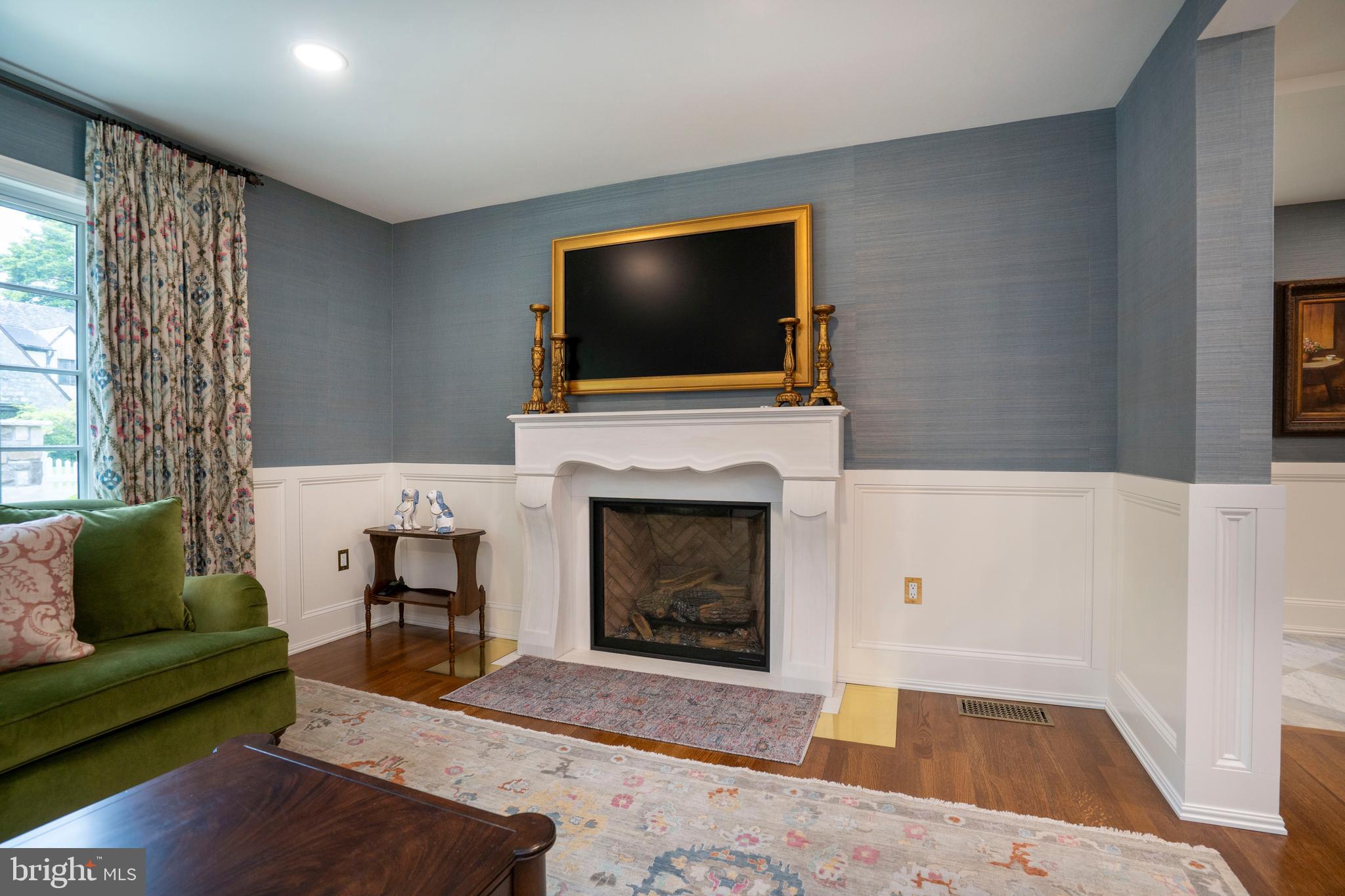 619 McKee Street State College, PA 16803 - Photo 38 of 101 a living room with furniture a flat screen tv and a fireplace