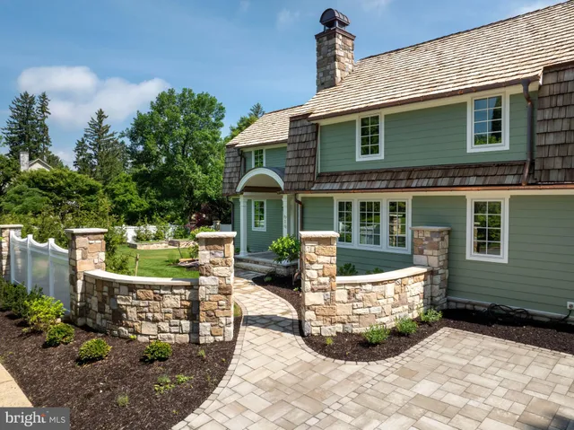a front view of a house with yard and outdoor seating