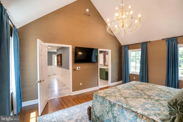 a view of a livingroom with furniture flat screen tv and windows