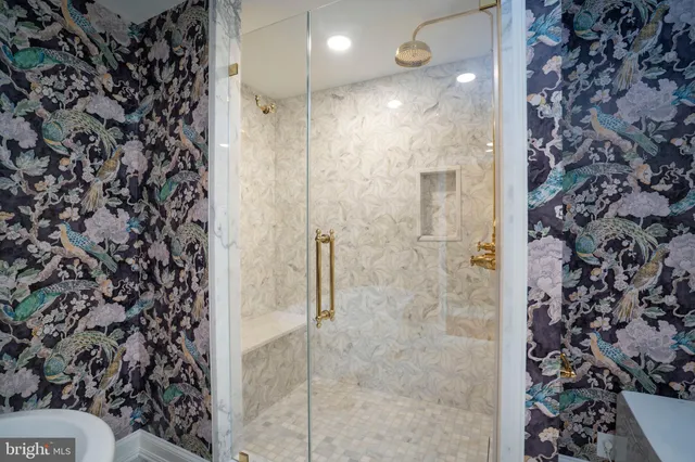 a living room with furniture a rug and a ceiling fan