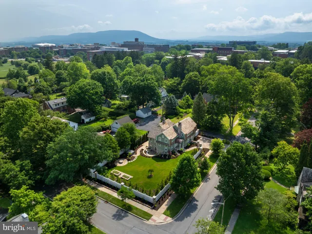 an aerial view of a house with garden space and street view
