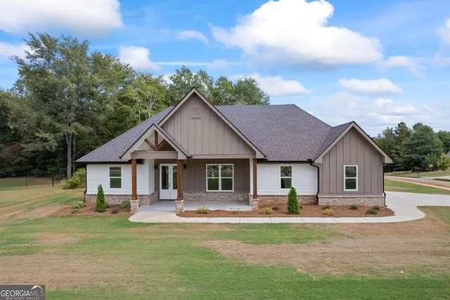 a front view of a house with a garden