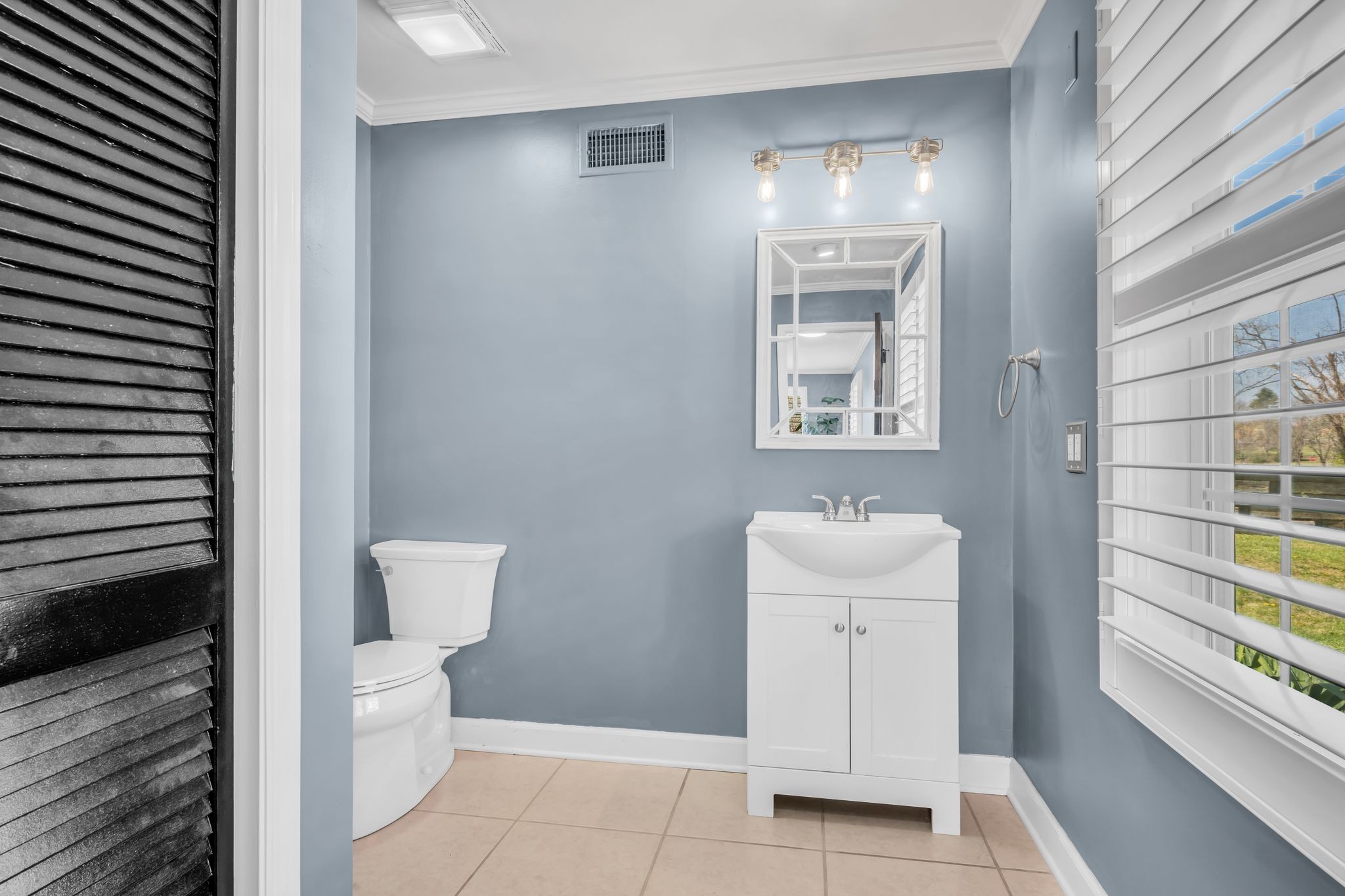 108 Lake Valley Road Dickson, TN 37055 - Photo 34 of 42 a bathroom with a toilet a sink and mirror
