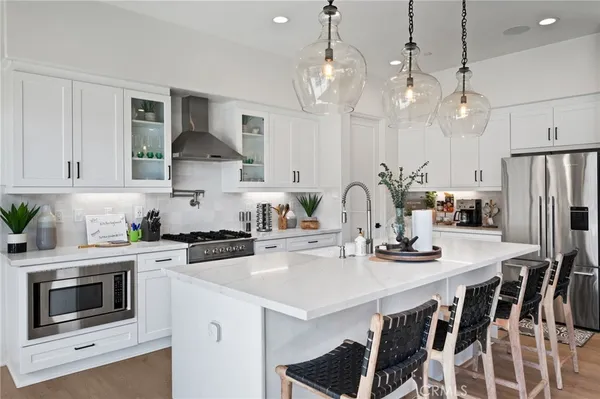 a kitchen with a white table and chairs