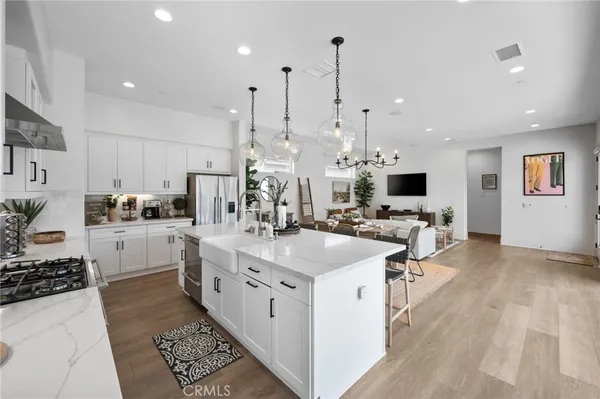 a kitchen with stainless steel appliances kitchen island granite countertop a sink and cabinets