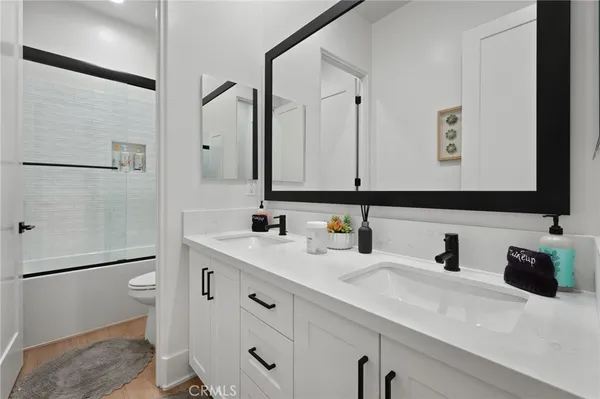 a bedroom with a bed and a potted plant