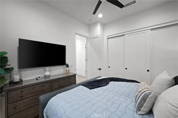 a bedroom with furniture and a flat screen tv