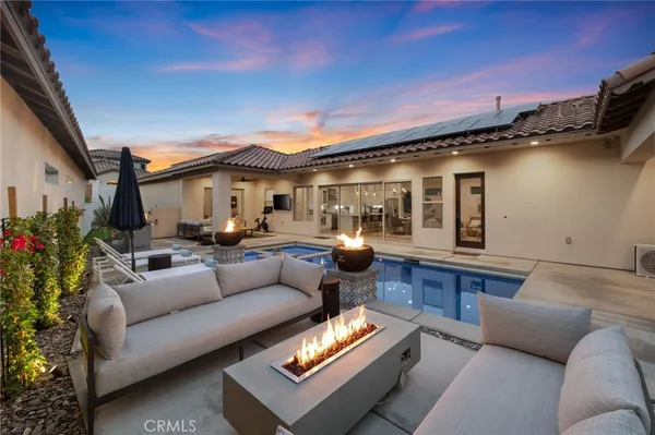 a living room with granite countertop a couch a rug and a potted plant