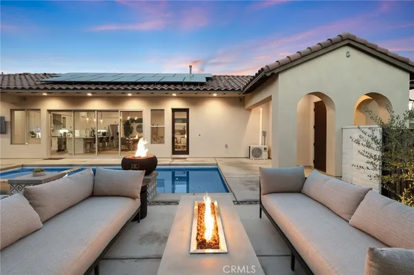 a living room with furniture a large window and a fireplace