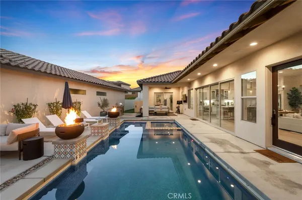 a view of a patio with swimming pool table and chairs