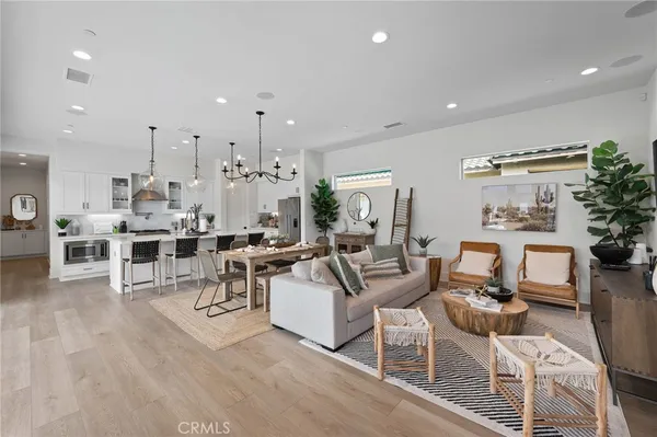 a living room with lots of furniture and a view of kitchen