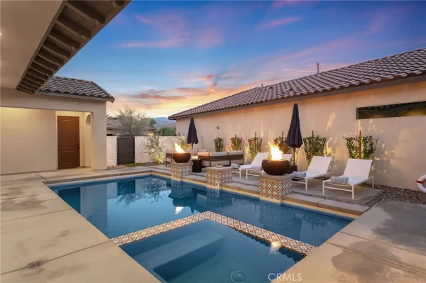 a view of a swimming pool with outdoor seating