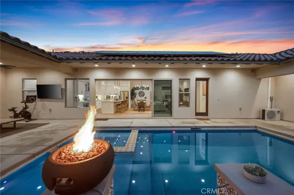 a view of a balcony with chairs and potted plants