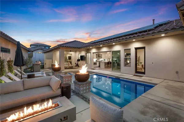 a view of a balcony with chairs and wooden floor