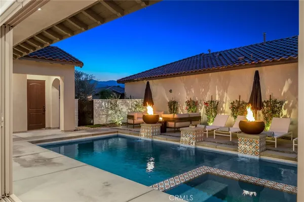 a view of a patio with couches table and chairs with potted plants