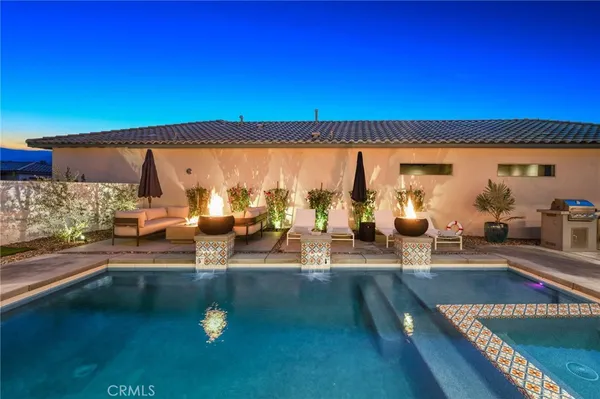a view of a patio with couches table and chairs and potted plants
