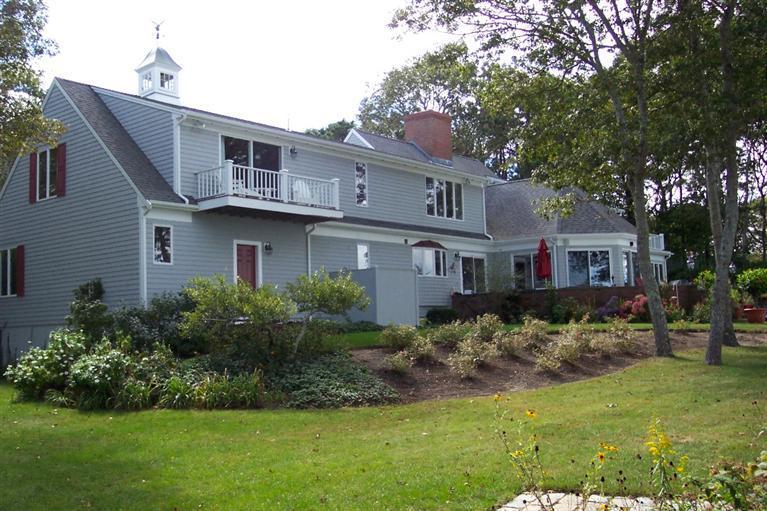 80 Great Bay Road Osterville, MA 02655 - Photo 4 of 10 a front view of a house with a garden