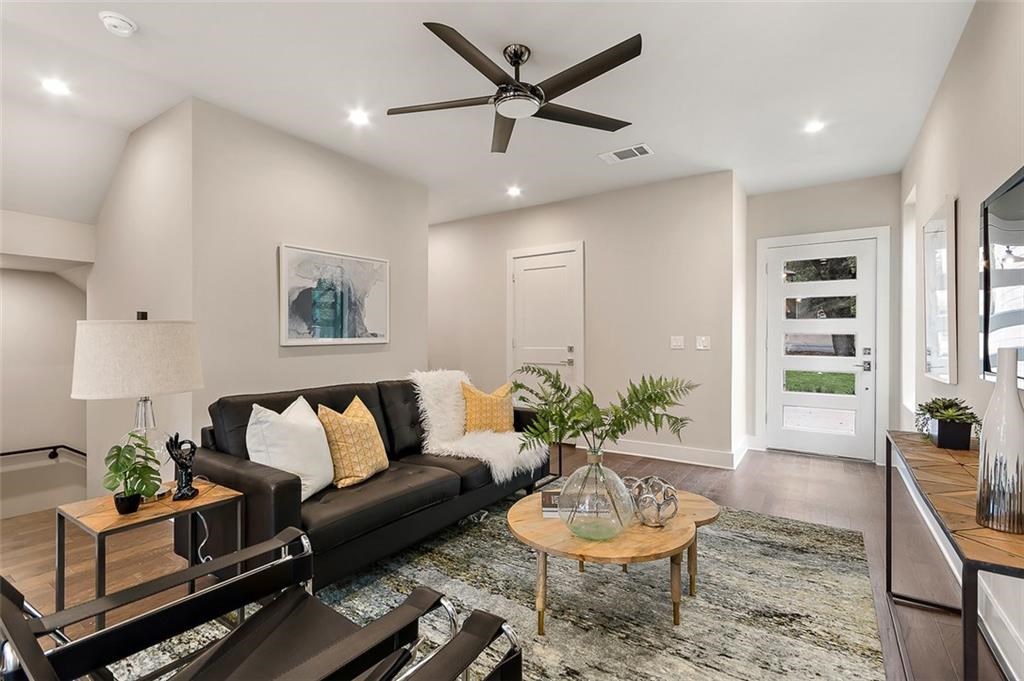 a living room with furniture and a potted plant