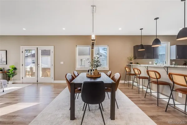 a dining room with furniture and wooden floor