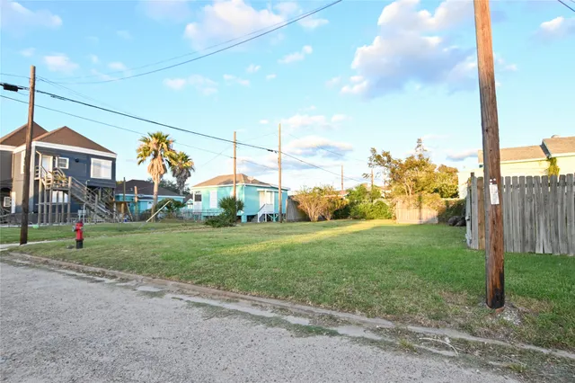 a view of a house with a big yard and a street