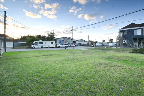a view of a house with a big yard and a large tree