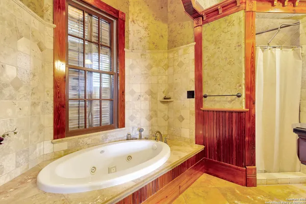 a bathroom with a tub and shower