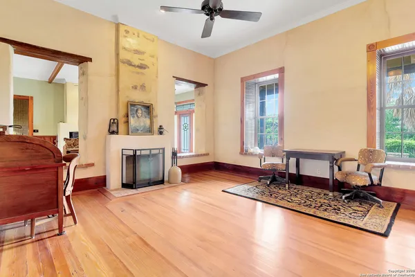 a living room with furniture a fireplace and a table