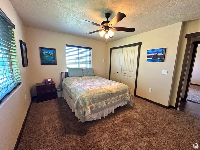 12 Crook Street Fish Haven, ID 83287 - Photo 21 of 35 Bedroom featuring a textured ceiling, a closet, a ceiling fan, and carpet floors