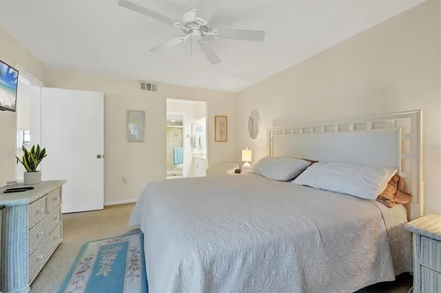 a bedroom with a bed chandelier and a window