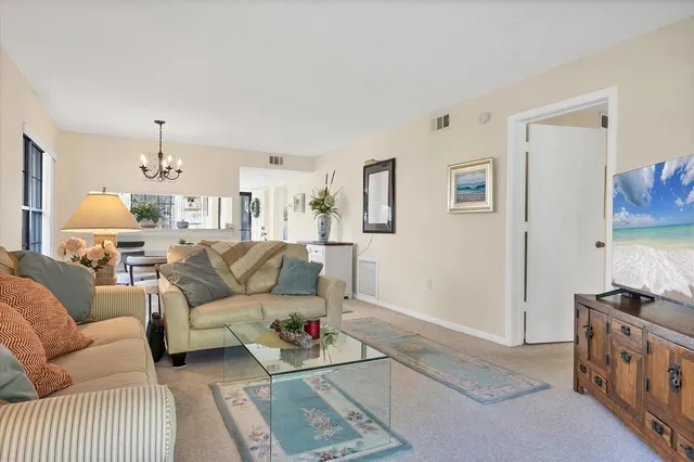 a living room with furniture and a dining table