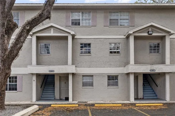 a front view of a house with a yard garage and balcony