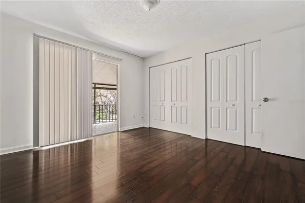 an empty room with wooden floor and a window