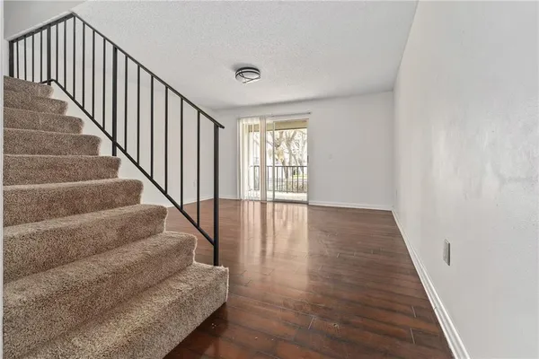 a view of staircase with wooden floor and a window