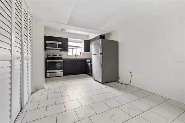 a kitchen with stainless steel appliances a refrigerator sink and stove