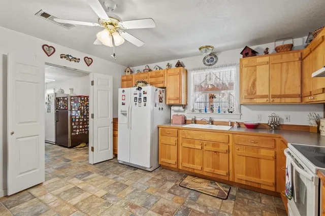 a view of a kitchen with a sink and cabinets