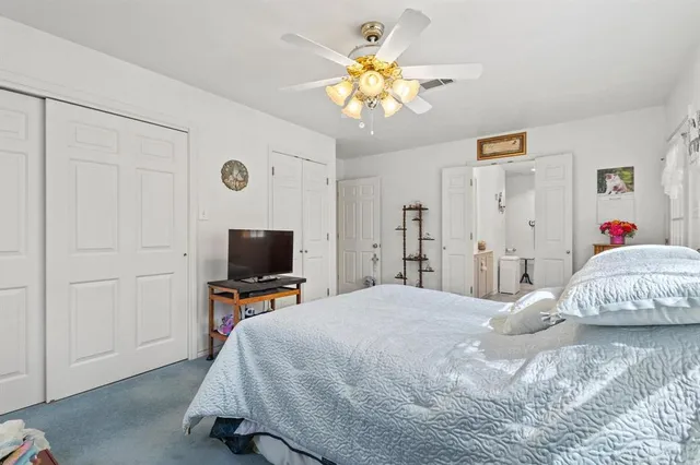 a bedroom that has a bed and a chandelier