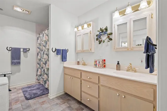 a bathroom with a sink a mirror and a shower