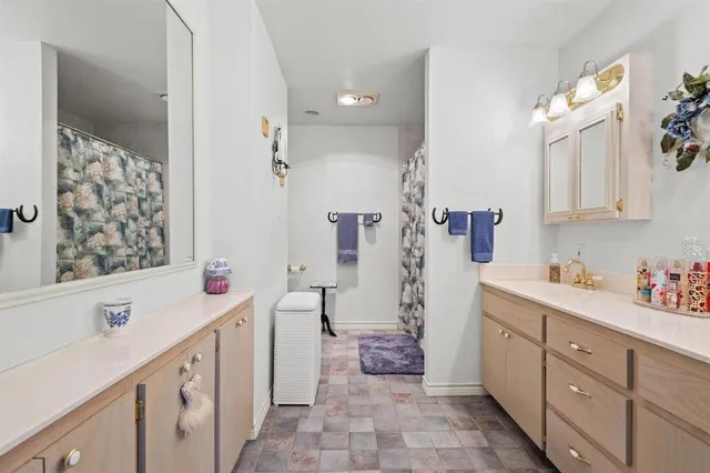 a bathroom with a sink mirror and a bathtub
