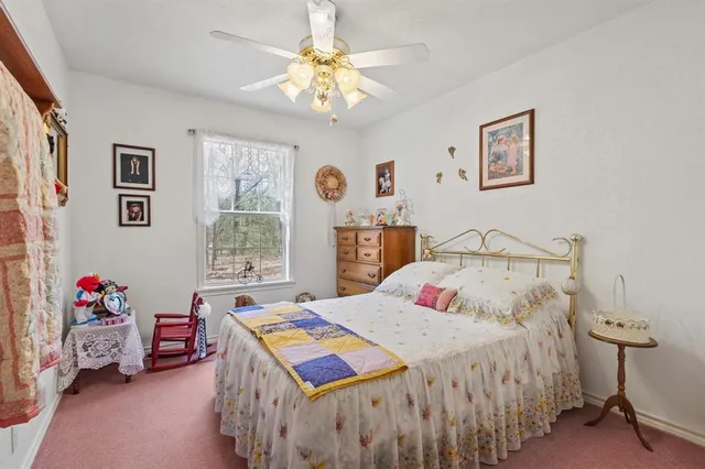 a bedroom that has a bed and a table in it