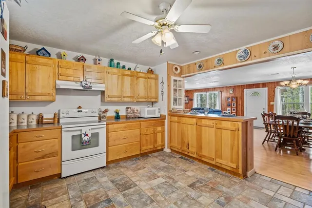 a kitchen with stainless steel appliances granite countertop a stove and white cabinets