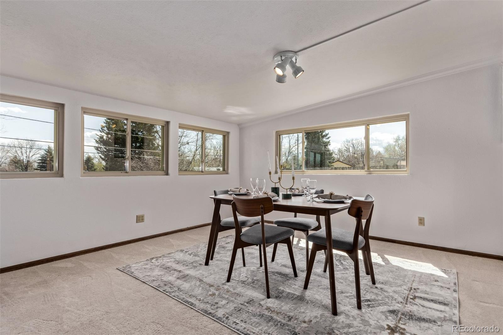7720 Kendall Street Arvada, CO 80003 - Photo 13 of 45 a view of a dining room with furniture a rug and wooden floor
