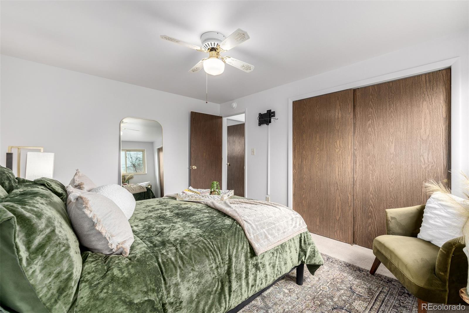 7720 Kendall Street Arvada, CO 80003 - Photo 15 of 45 a spacious bedroom with a bed and furniture