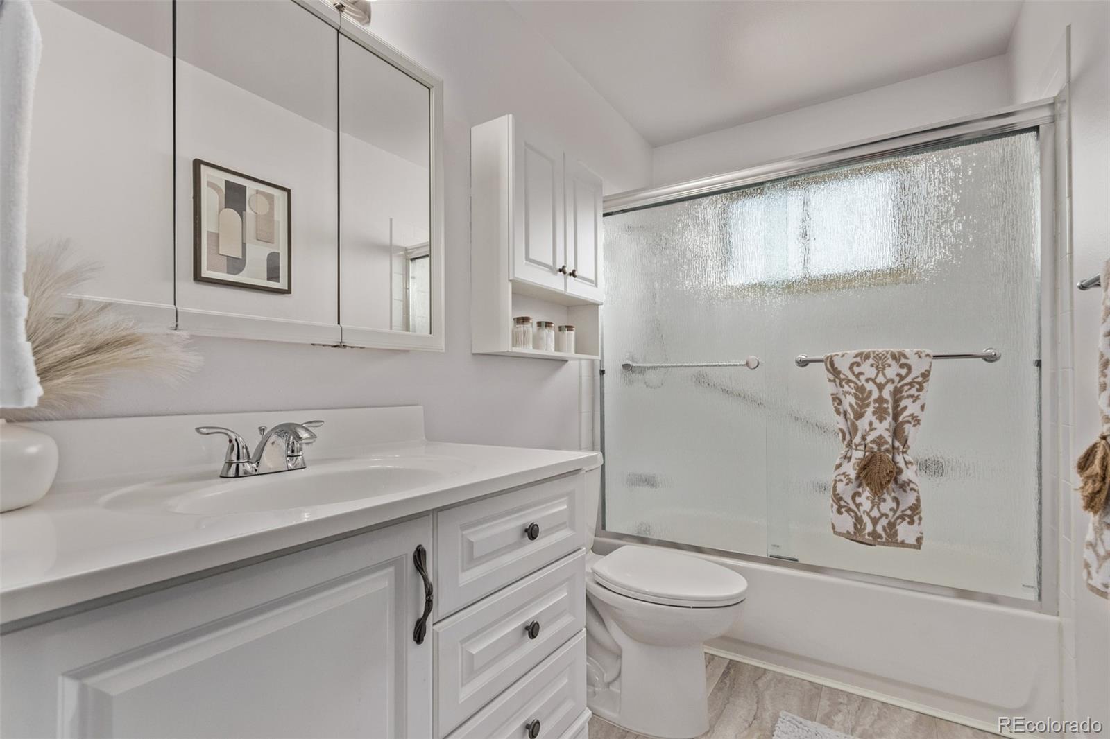 7720 Kendall Street Arvada, CO 80003 - Photo 19 of 45 a bathroom with a sink a toilet and shower