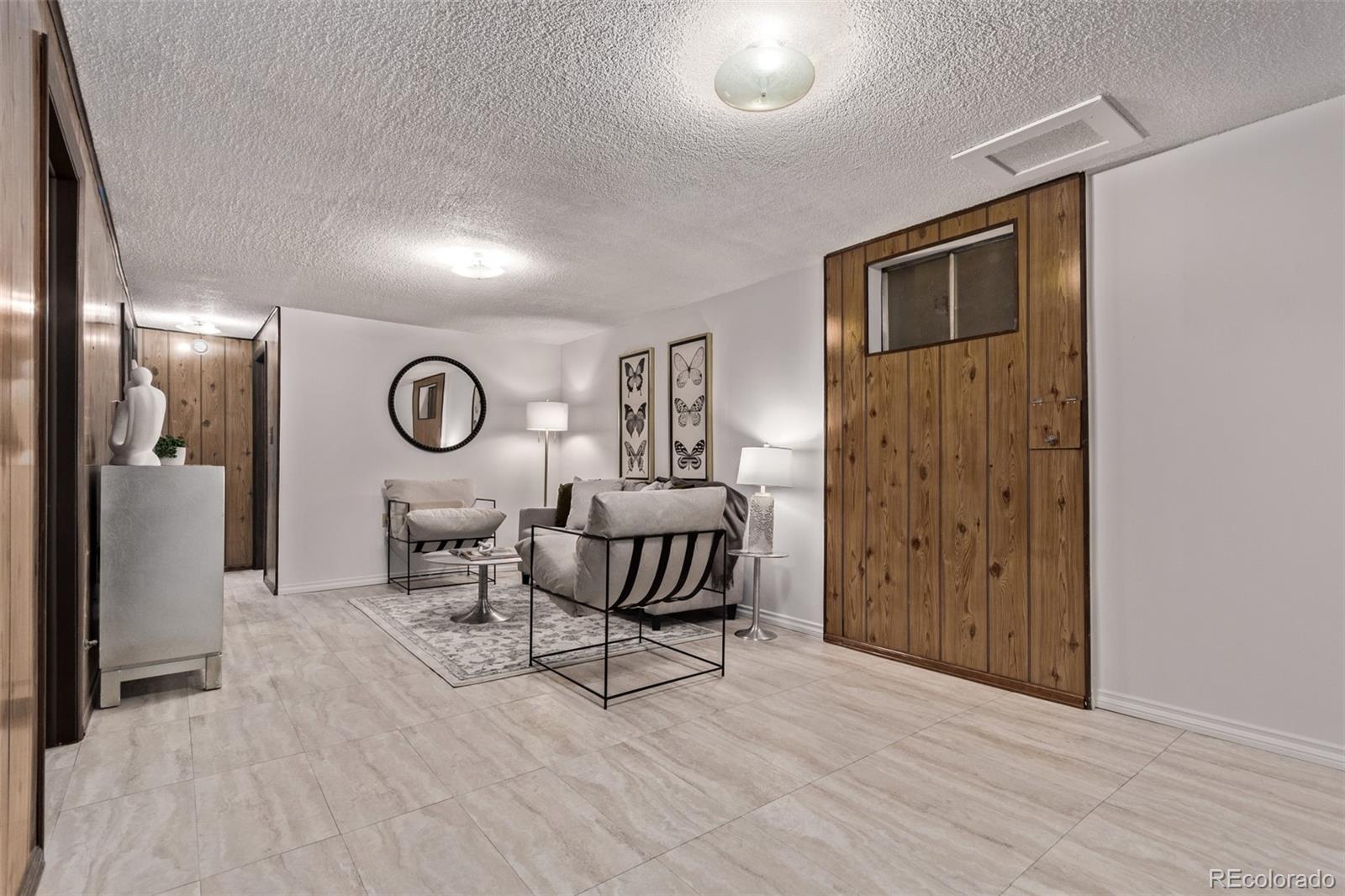 7720 Kendall Street Arvada, CO 80003 - Photo 23 of 45 a living room with furniture and a window