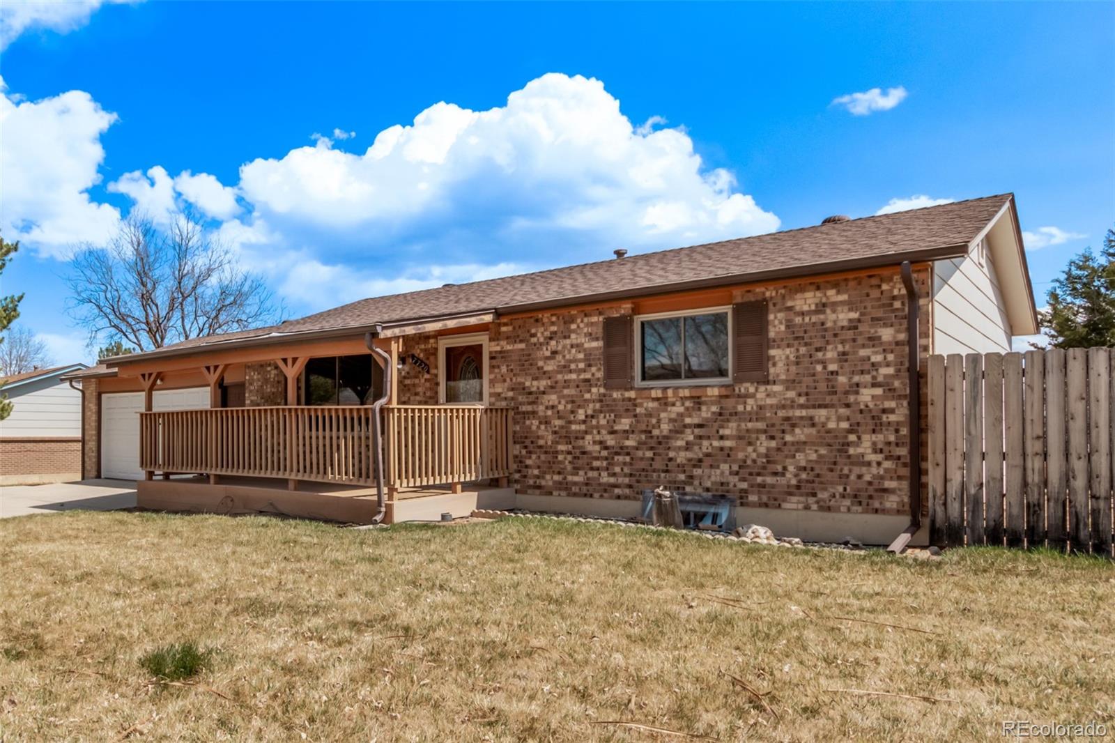 7720 Kendall Street Arvada, CO 80003 - Photo 37 of 45 a front view of a house with a yard