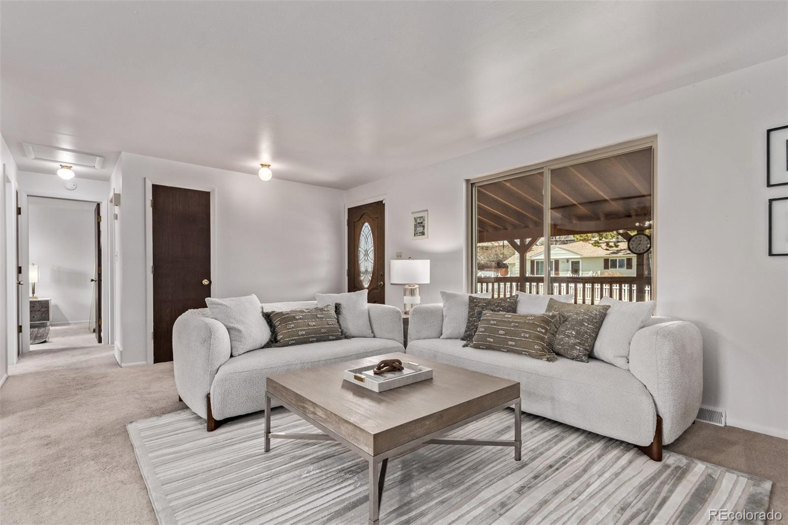 7720 Kendall Street Arvada, CO 80003 - Photo 4 of 45 a living room with furniture and a large window