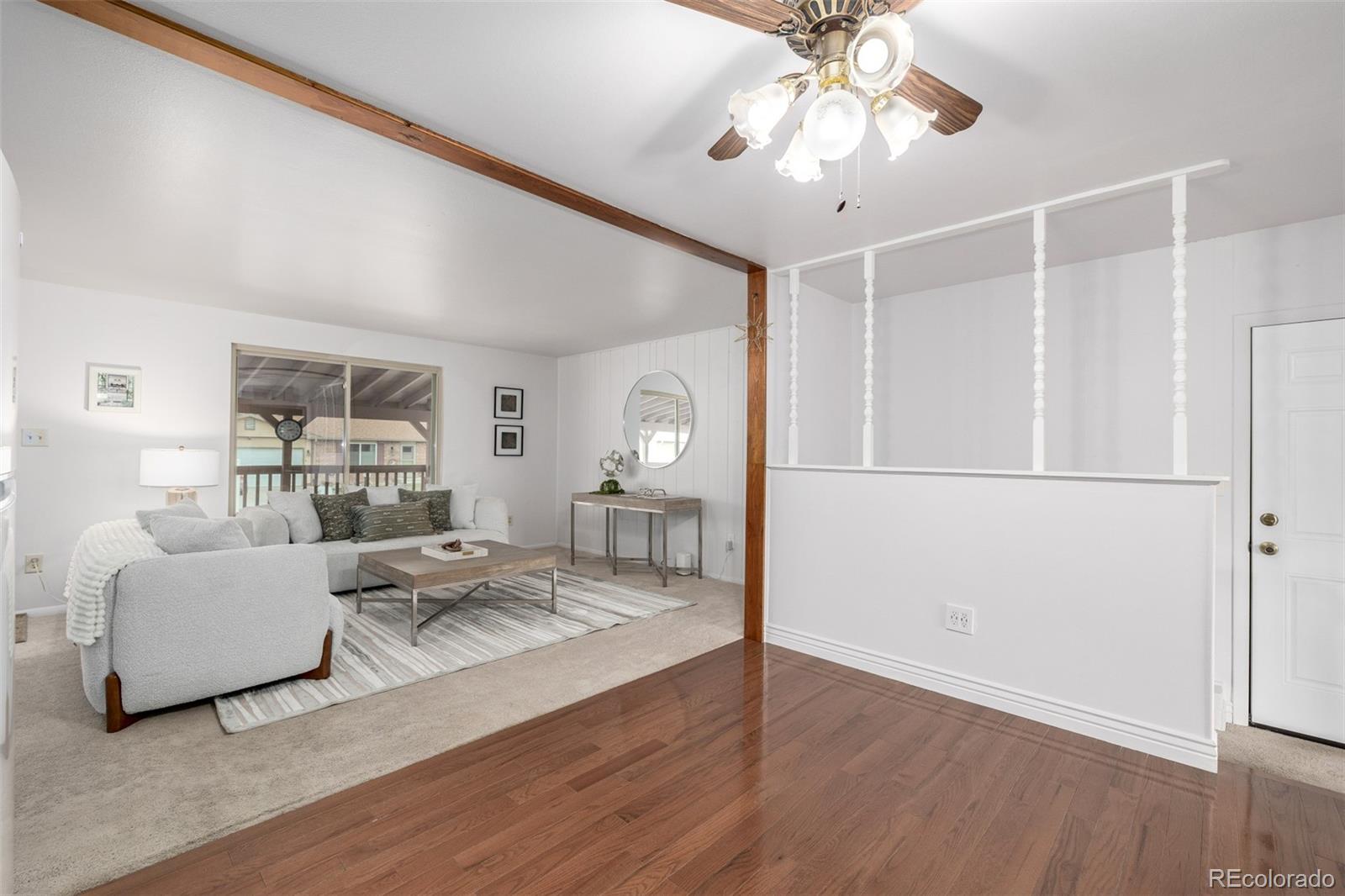 7720 Kendall Street Arvada, CO 80003 - Photo 10 of 45 a living room with furniture and a wooden floor