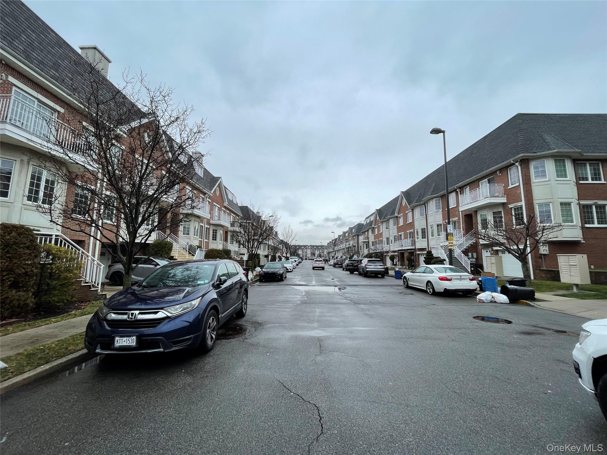 350 Soundview Lane Queens, NY 11356 - Photo 3 of 11 a view of a cars parked in front of a house