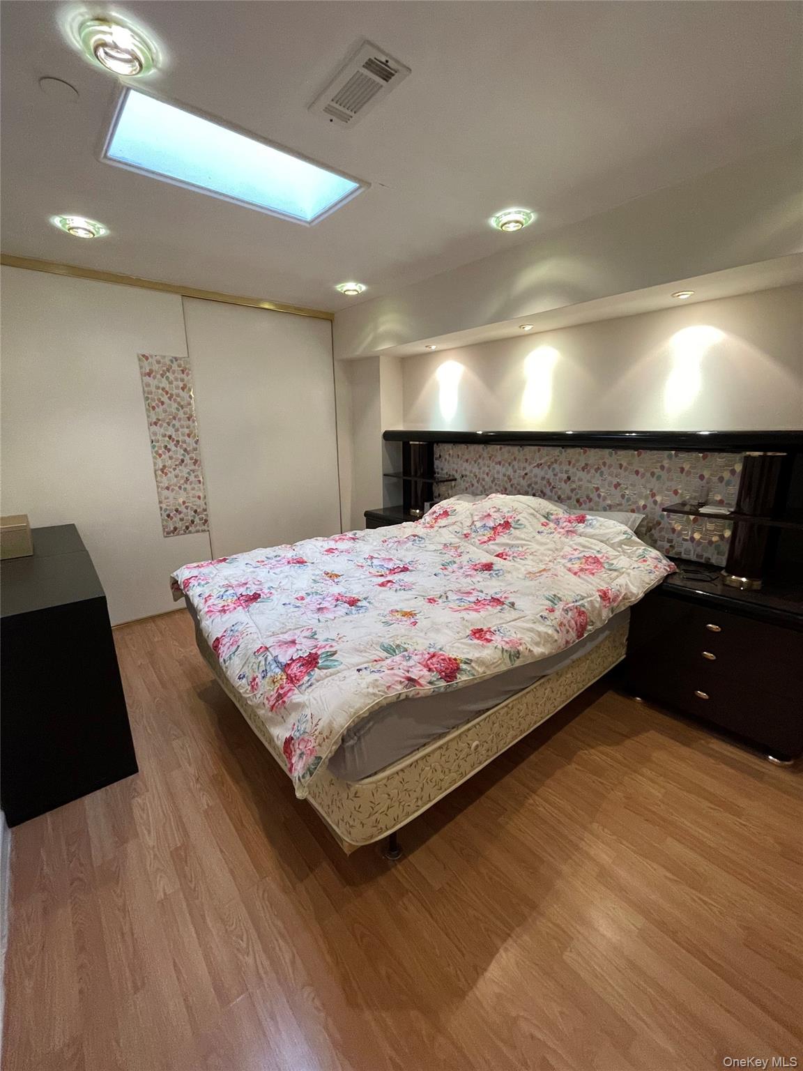 350 Soundview Lane Queens, NY 11356 - Photo 6 of 11 a bedroom with a bed and lamp