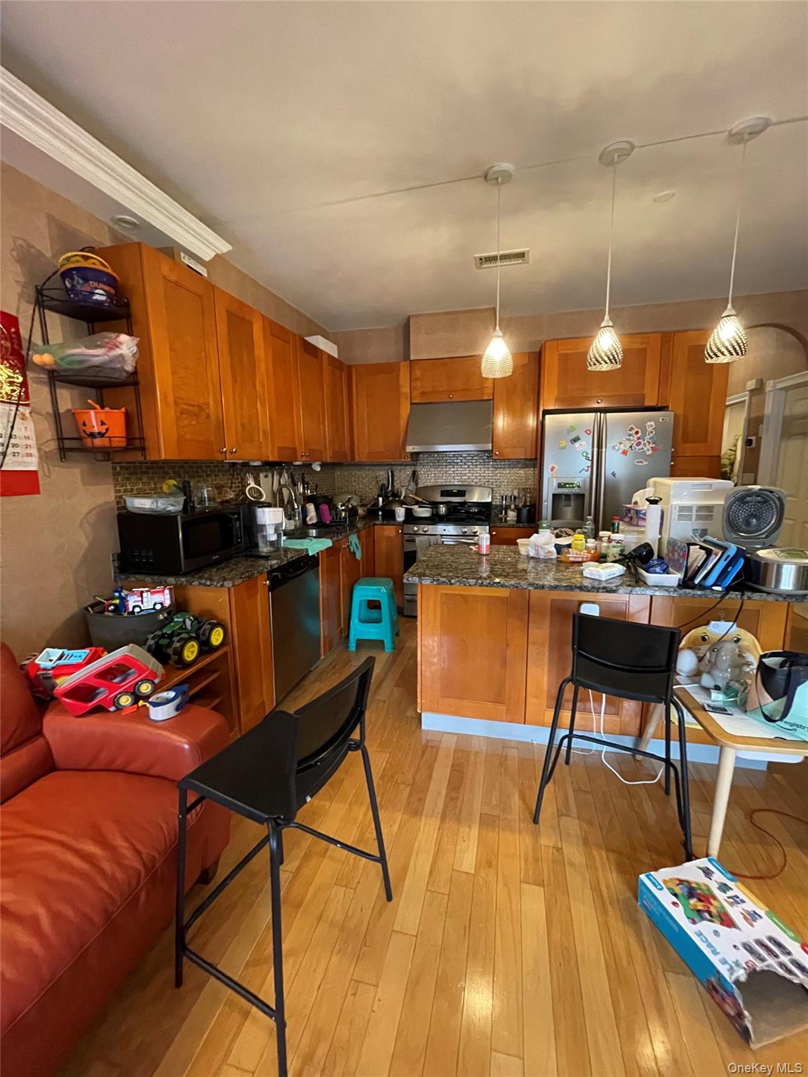 350 Soundview Lane Queens, NY 11356 - Photo 8 of 11 a living room with furniture and a wooden floor